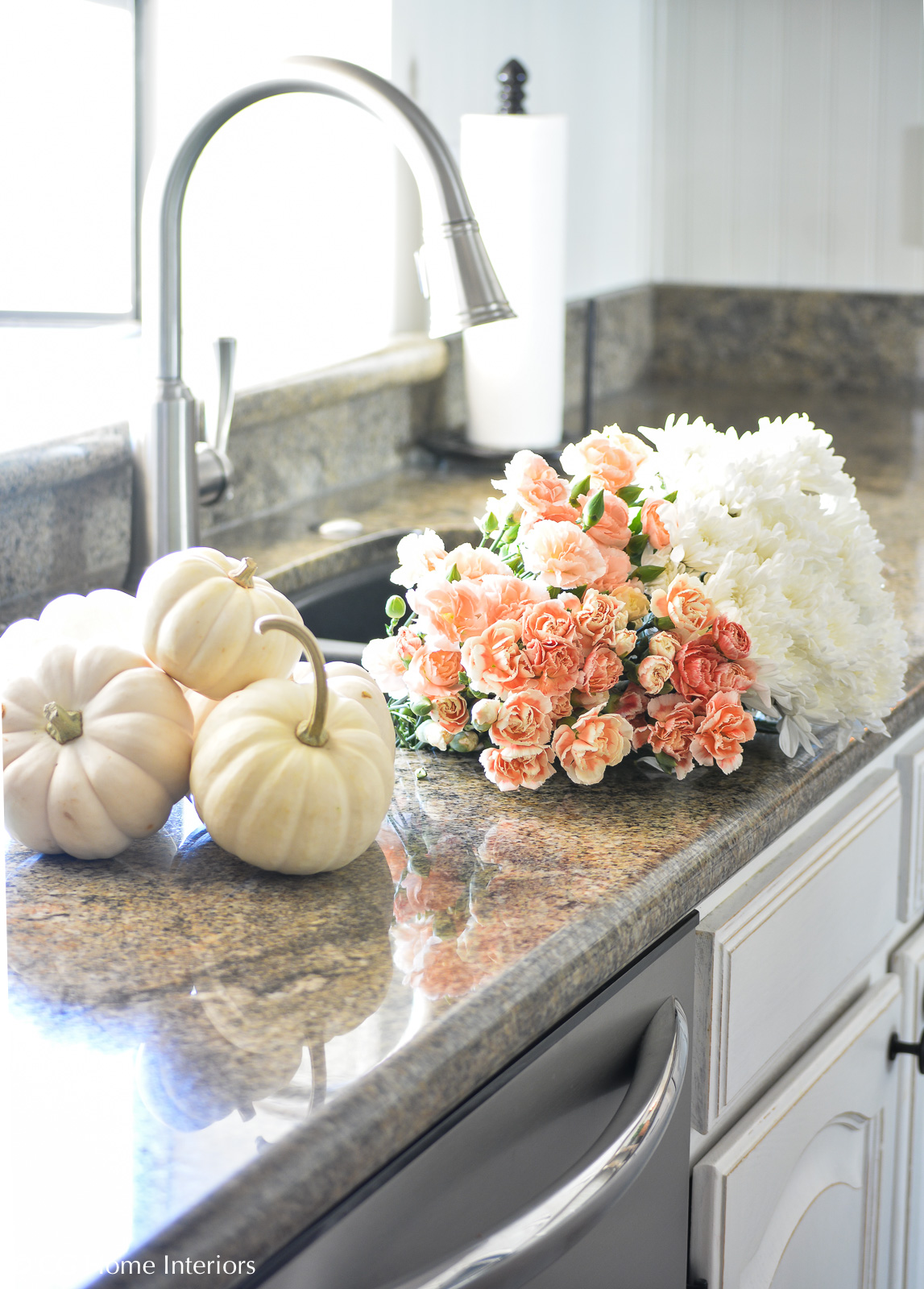 Fall flowers and pumpkins in white kitchen