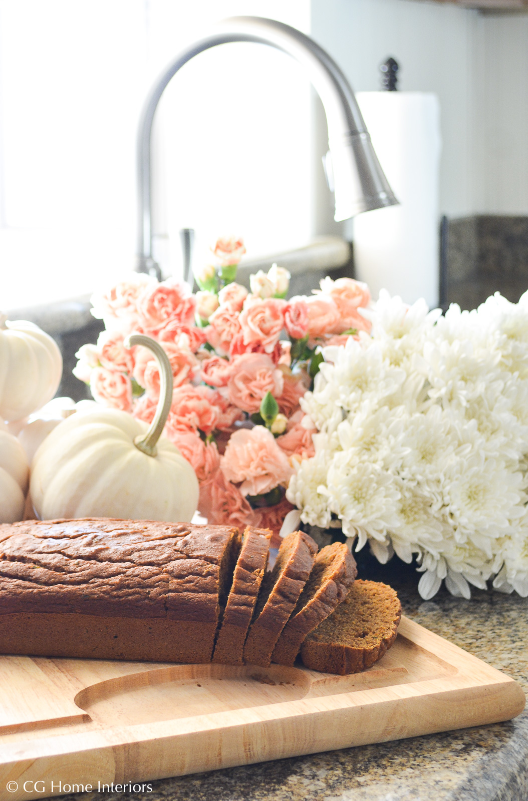 Healthy Pumpkin Zucchini Bread with Fall Flowers and white pumpkins